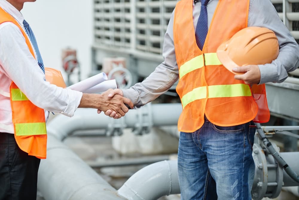 two workers shaking hands