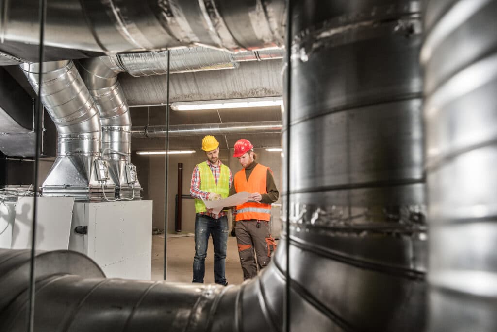 Workers,making,final,touches,to,hvac,system.,hvac,system,stands