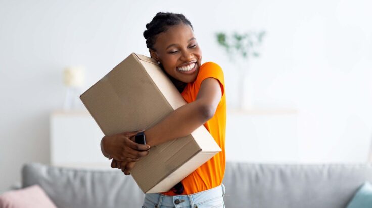 Happy Woman Customer Hugging A Box Aspect Ratio 1472 816