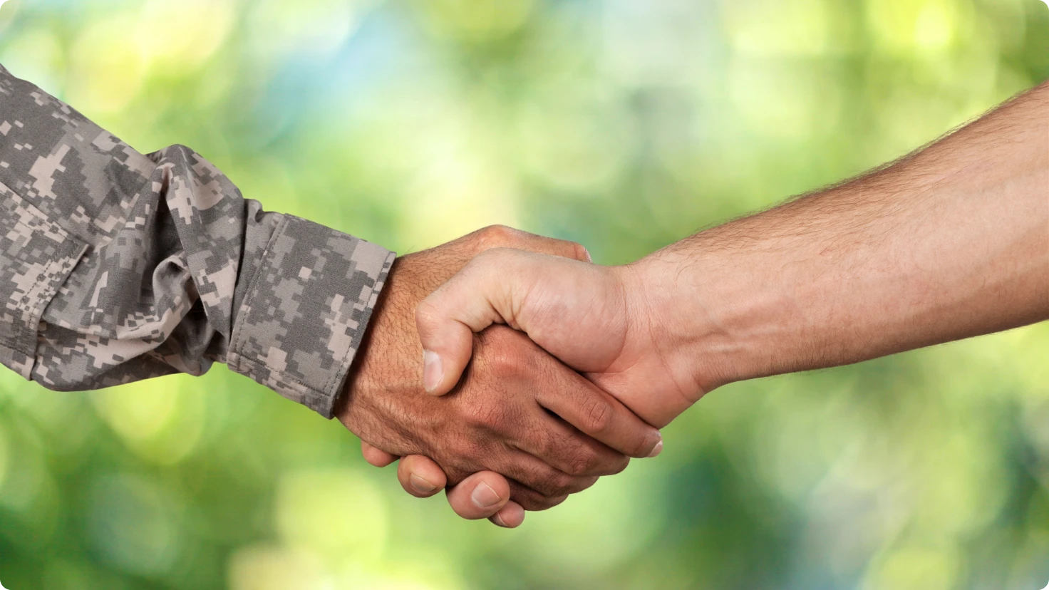 Military Person And Civilian Shaking Hands